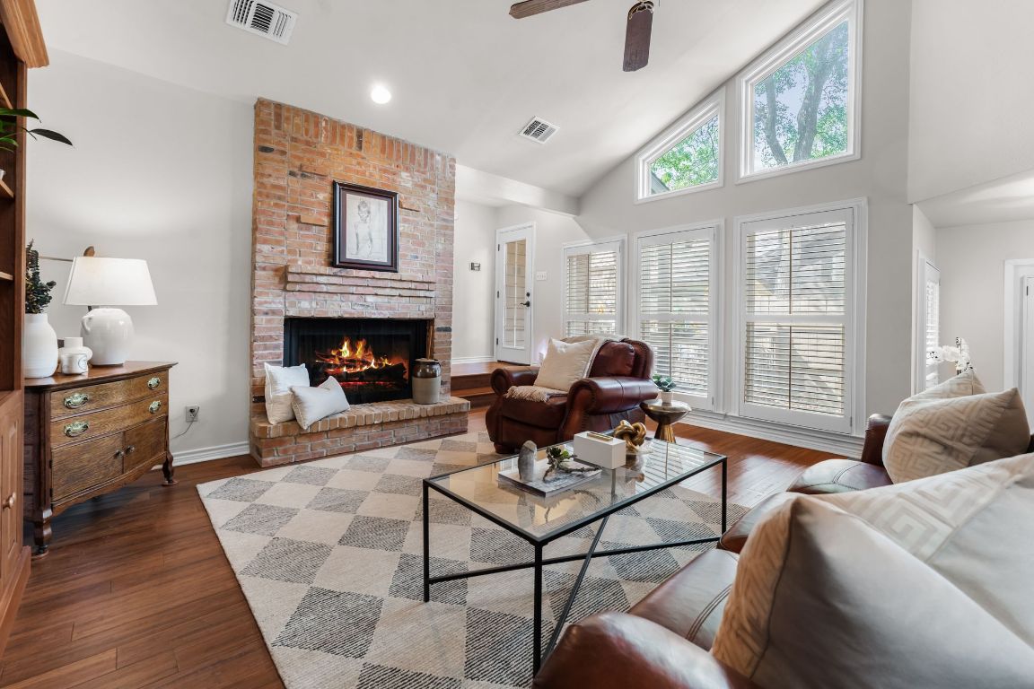 8125 Forest Mesa Drive Austin, TX 78759 - Photo 1 of 1 a living room with furniture two windows and a fireplace