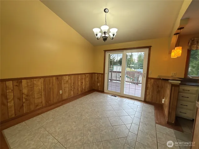 a view of a room with wooden floor and windows