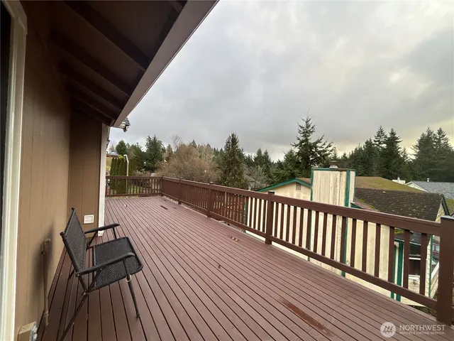 a view of balcony with wooden floor and fence