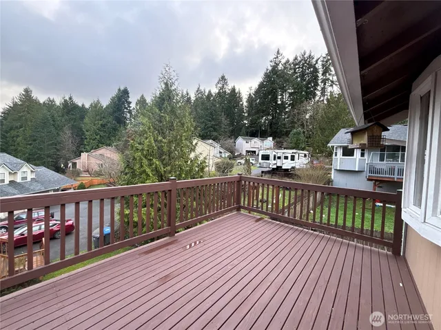 a view of a balcony with wooden floor and outdoor space