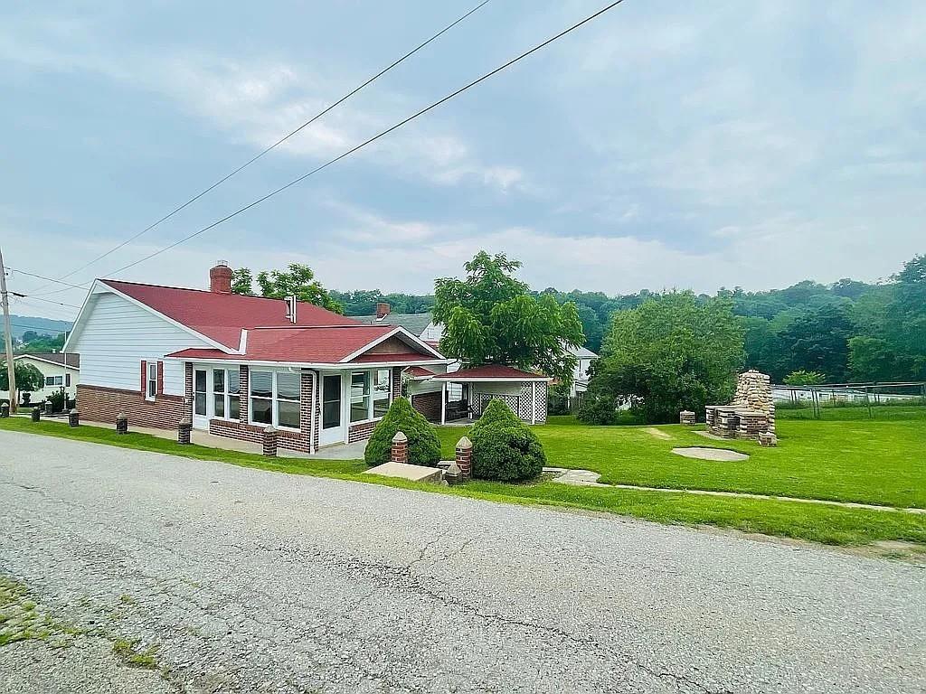 449 Race Street Waynesburg, PA 15370 - Photo 3 of 20 a front view of a house with a yard and trees