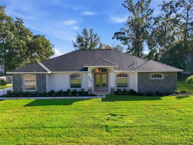 a front view of house with yard and green space