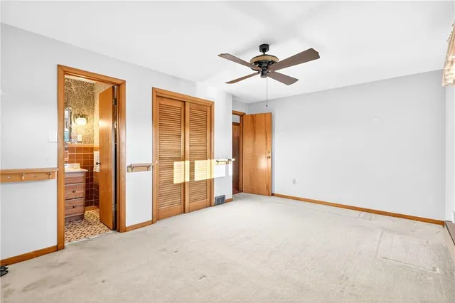 an empty room with windows and closet