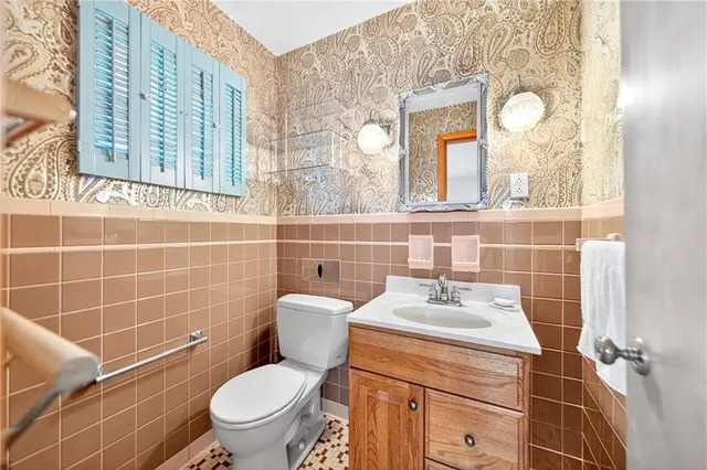 a bathroom with a sink a toilet and a mirror