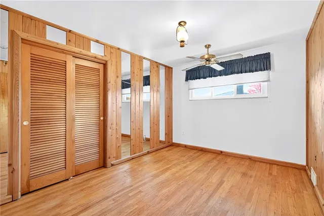 a view of a livingroom with wooden floor and a ceiling fan