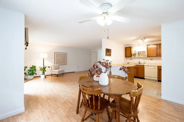 a view of a dining room with furniture and a chandelier fan