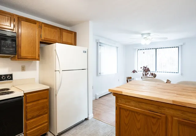 a kitchen with a refrigerator and a sink