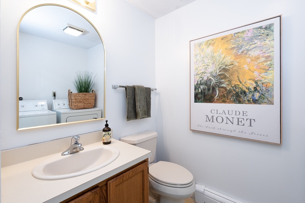 98 Indian Rock Road, Unit 98 Merrimack, NH 03054 - Photo 17 of 40 a bathroom with a sink a mirror and a toilet