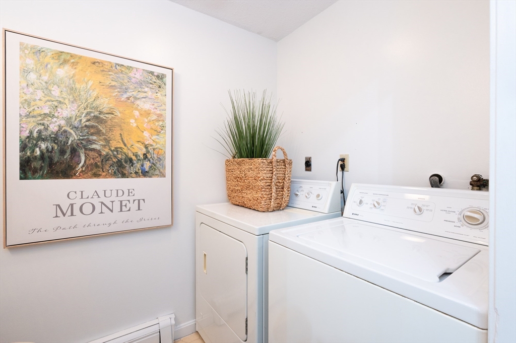 98 Indian Rock Road, Unit 98 Merrimack, NH 03054 - Photo 18 of 40 a view of washer and dryer with bathroom in the background