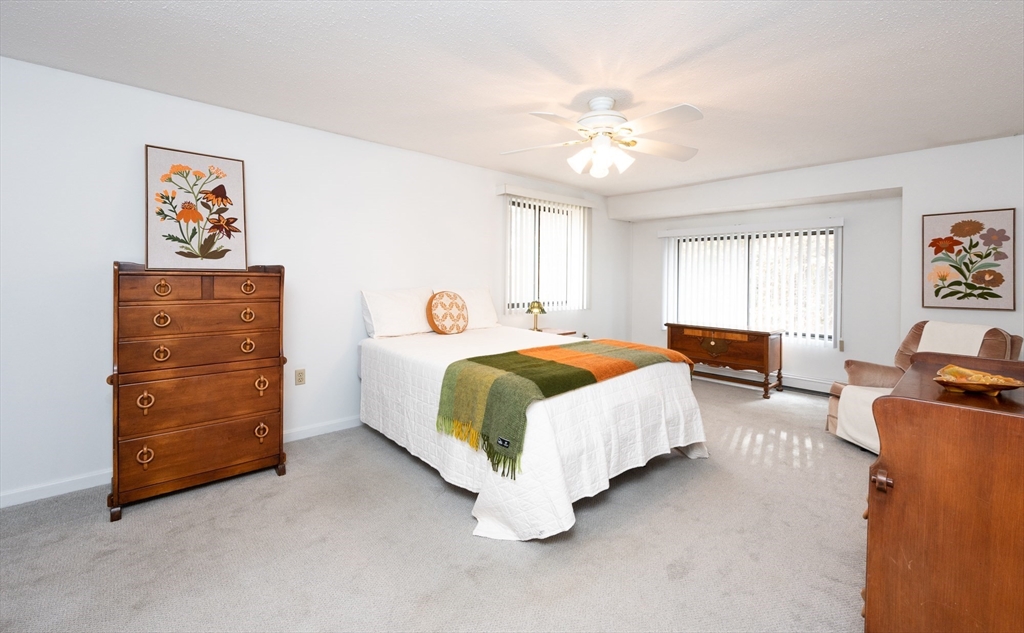 98 Indian Rock Road, Unit 98 Merrimack, NH 03054 - Photo 20 of 40 a spacious bedroom with a bed and dresser