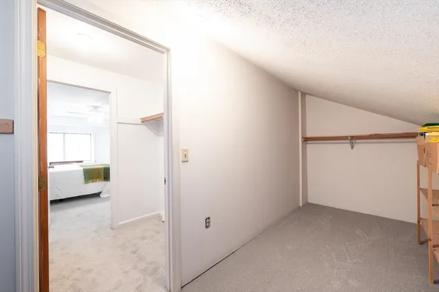 a view of a room that has a bed in it