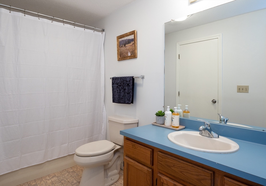 98 Indian Rock Road, Unit 98 Merrimack, NH 03054 - Photo 25 of 40 a bathroom with a toilet sink and mirror