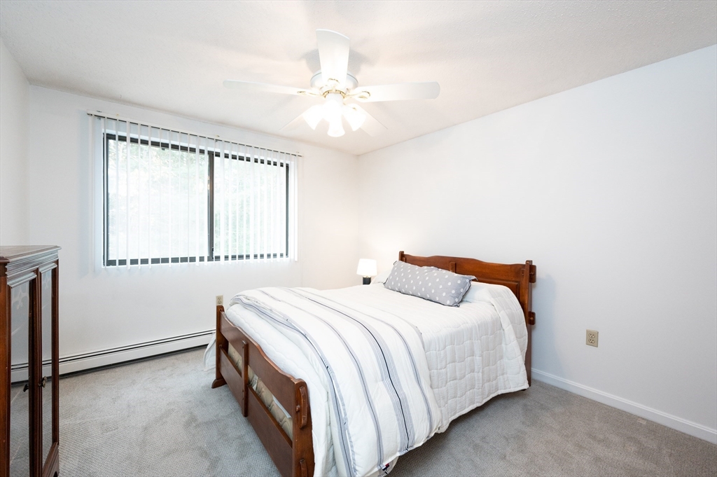 98 Indian Rock Road, Unit 98 Merrimack, NH 03054 - Photo 26 of 40 a bedroom with a bed and a window