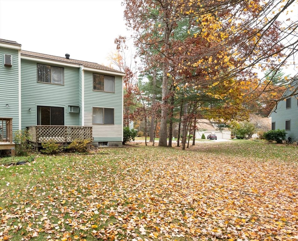 98 Indian Rock Road, Unit 98 Merrimack, NH 03054 - Photo 30 of 40 a view of a house with a yard