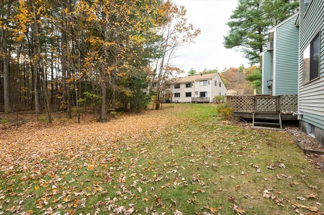 a backyard of a house with table and chairs