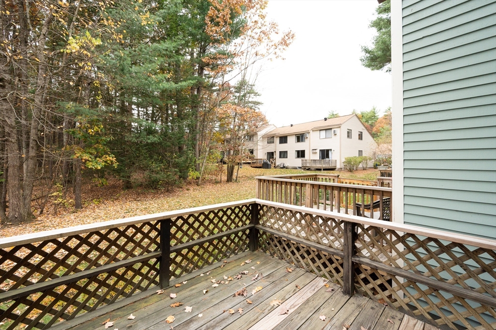 98 Indian Rock Road, Unit 98 Merrimack, NH 03054 - Photo 34 of 40 a balcony with wooden floor and city view