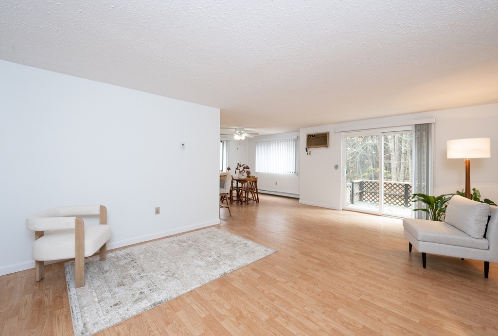 98 Indian Rock Road, Unit 98 Merrimack, NH 03054 - Photo 6 of 40 a living room with furniture and a table