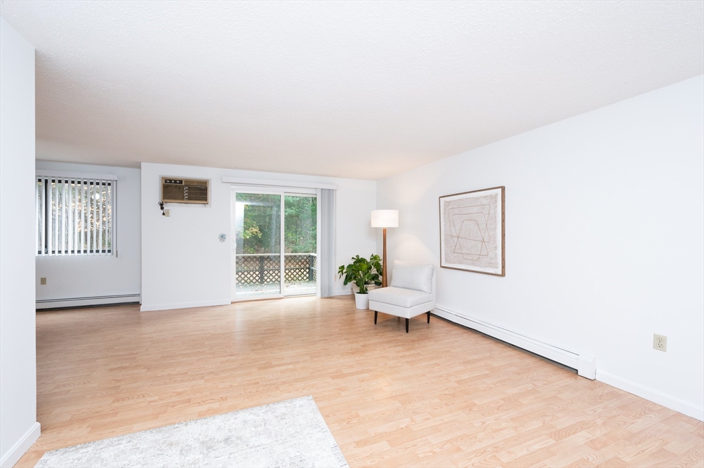 98 Indian Rock Road, Unit 98 Merrimack, NH 03054 - Photo 7 of 40 a living room with furniture and a window