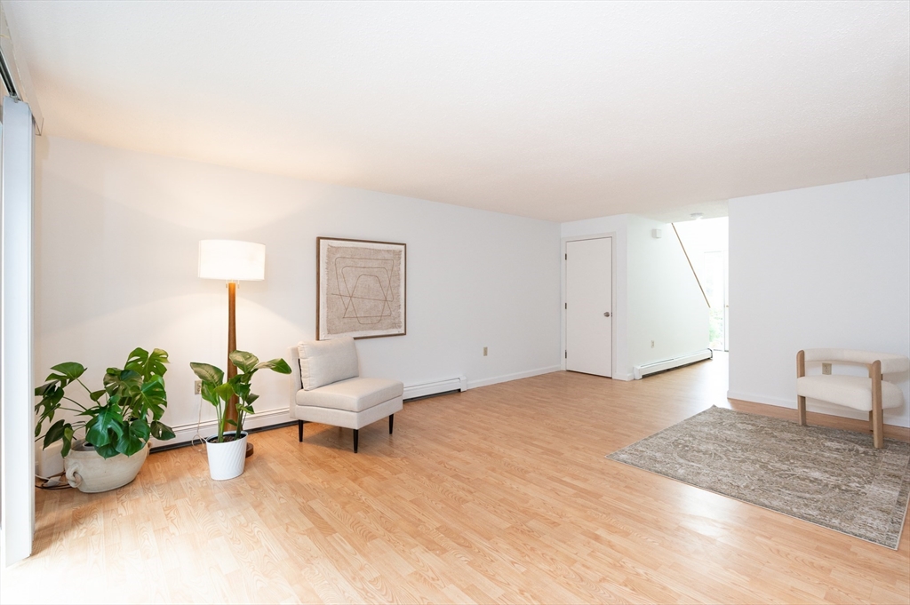 98 Indian Rock Road, Unit 98 Merrimack, NH 03054 - Photo 8 of 40 a living room with furniture and a potted plant