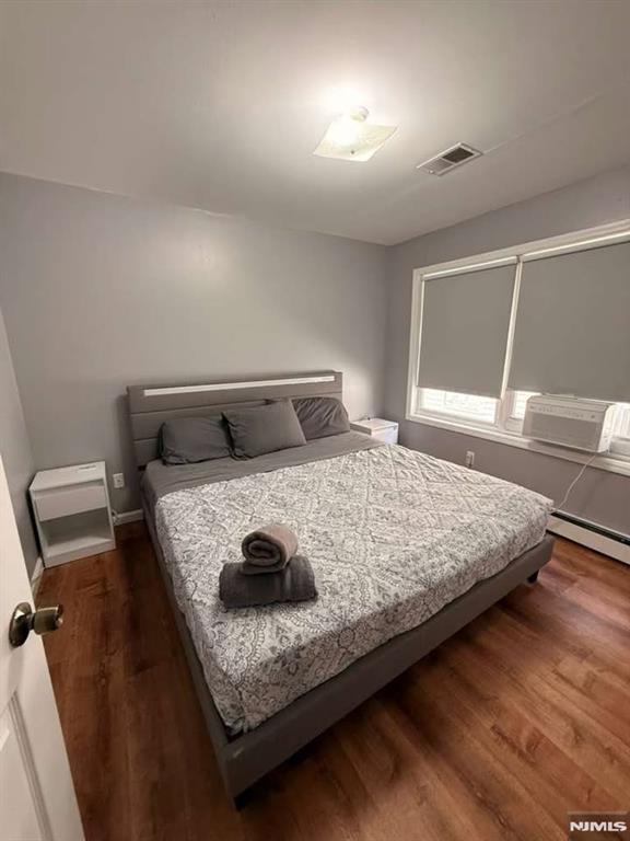 168 Grove Street Passaic, NJ 07055 - Photo 2 of 12 a bedroom with a bed and window