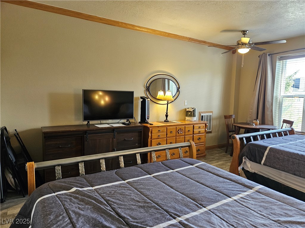 223 Hunter Ridge Drive, Unit 121 Brian Head, UT 84719 - Photo 15 of 35 Bedroom featuring a textured ceiling and light wood-style floors