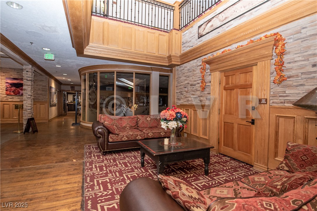 223 Hunter Ridge Drive, Unit 121 Brian Head, UT 84719 - Photo 22 of 35 Living area featuring wainscoting, crown molding, wood finished floors, decorative columns, and recessed lighting