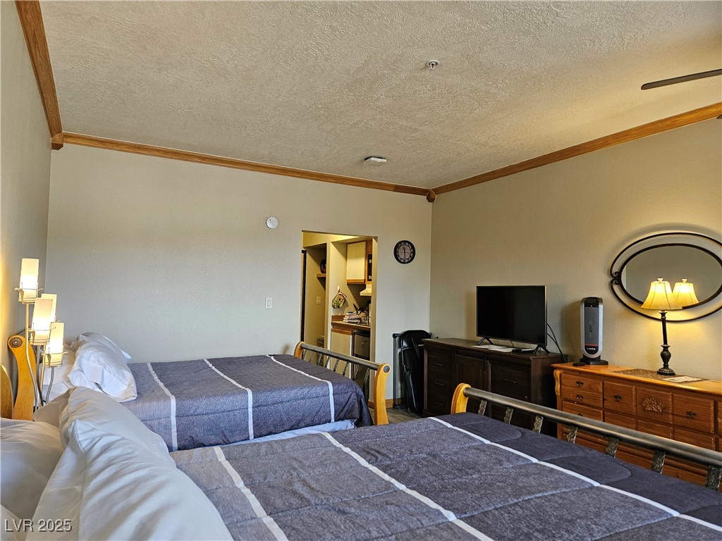 223 Hunter Ridge Drive, Unit 121 Brian Head, UT 84719 - Photo 6 of 35 Bedroom featuring ornamental molding and a textured ceiling