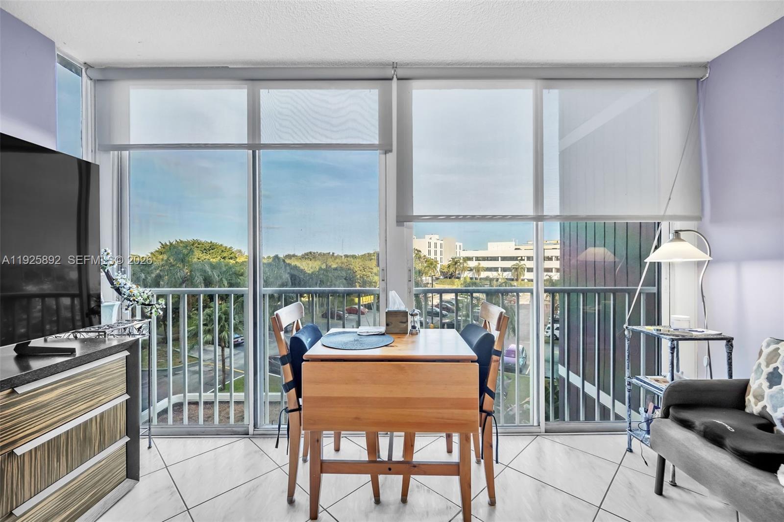 a dining room with furniture water view and a flat screen tv
