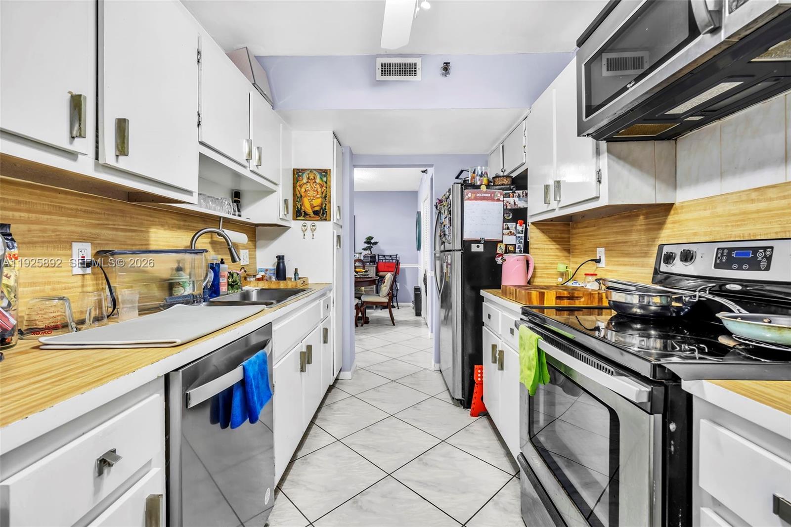 3850 Washington Street, Unit 409 Hollywood, FL 33021 - Photo 11 of 18 a kitchen with stainless steel appliances granite countertop a stove and cabinets