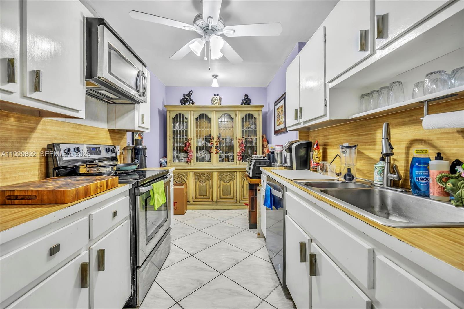 3850 Washington Street, Unit 409 Hollywood, FL 33021 - Photo 12 of 18 a kitchen with stainless steel appliances granite countertop a sink and cabinets