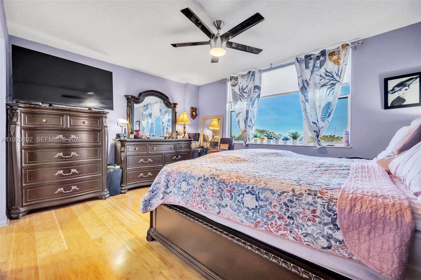 3850 Washington Street, Unit 409 Hollywood, FL 33021 - Photo 14 of 18 a bedroom with a bed and a flat screen tv