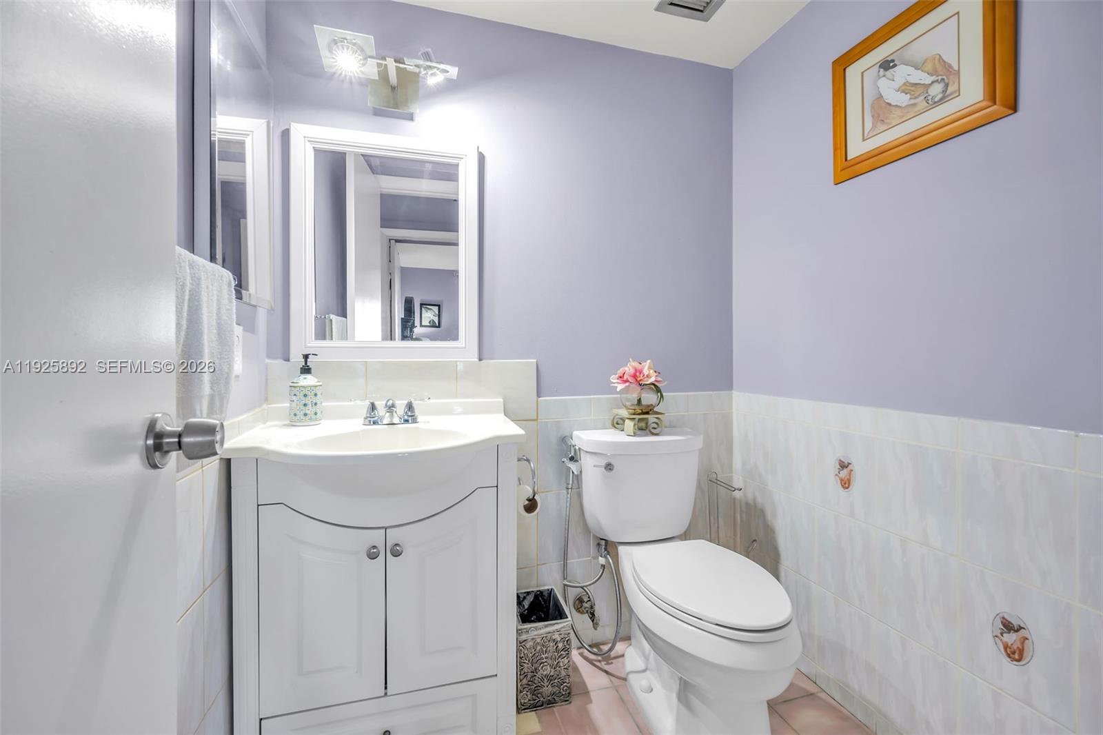 3850 Washington Street, Unit 409 Hollywood, FL 33021 - Photo 16 of 18 a bathroom with a sink toilet and mirror