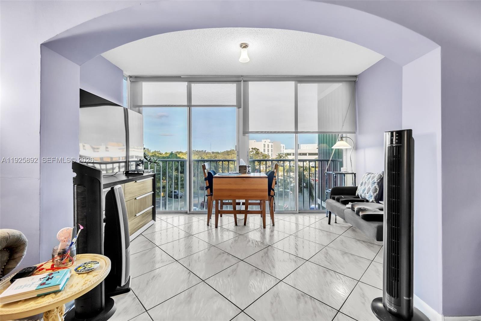 3850 Washington Street, Unit 409 Hollywood, FL 33021 - Photo 4 of 18 a outdoor living space with furniture and a fireplace