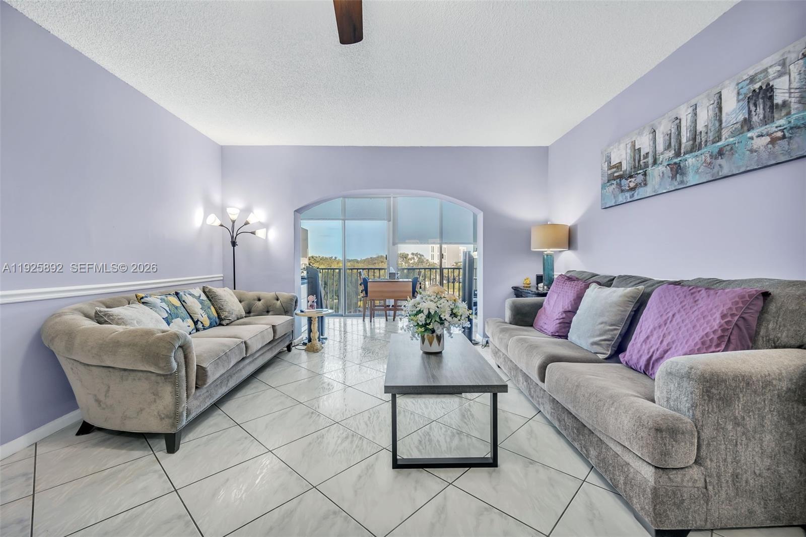 3850 Washington Street, Unit 409 Hollywood, FL 33021 - Photo 6 of 18 a living room with furniture and a chandelier