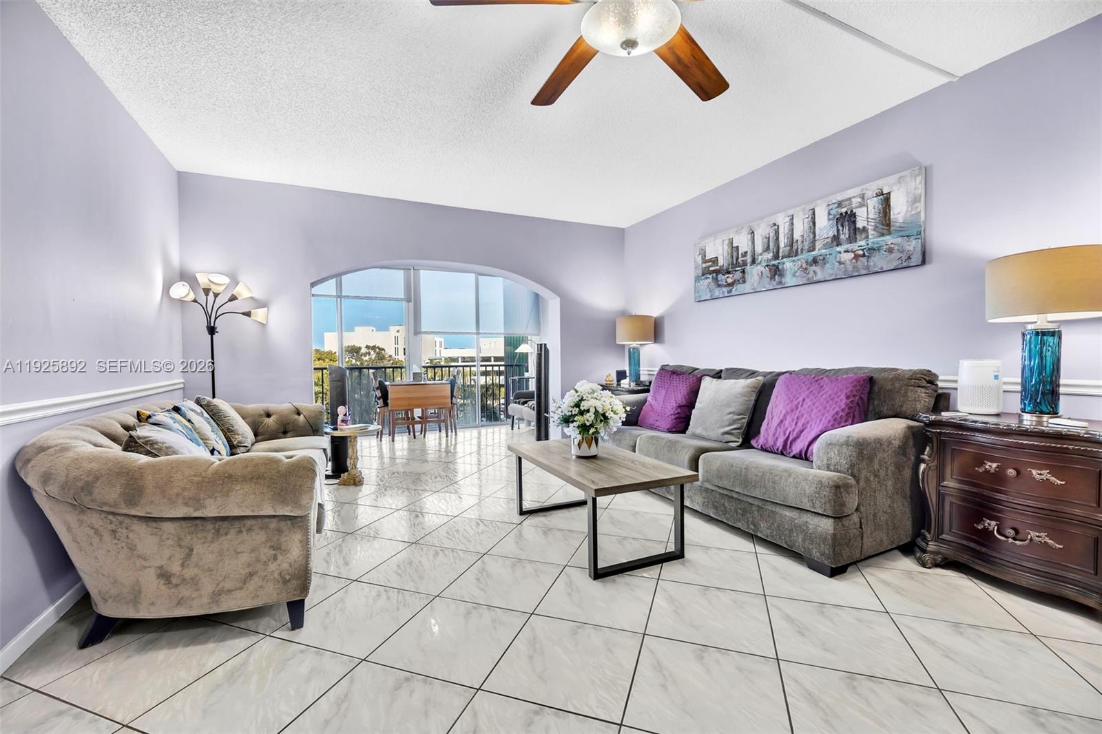 3850 Washington Street, Unit 409 Hollywood, FL 33021 - Photo 7 of 18 a living room with furniture and a chandelier