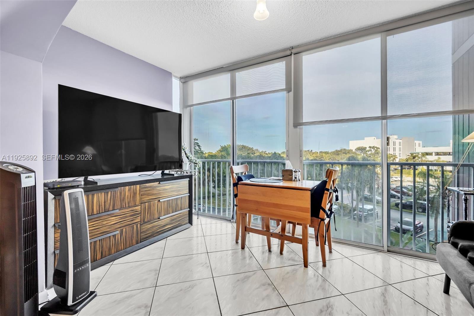 3850 Washington Street, Unit 409 Hollywood, FL 33021 - Photo 8 of 18 a room with furniture and a flat screen tv