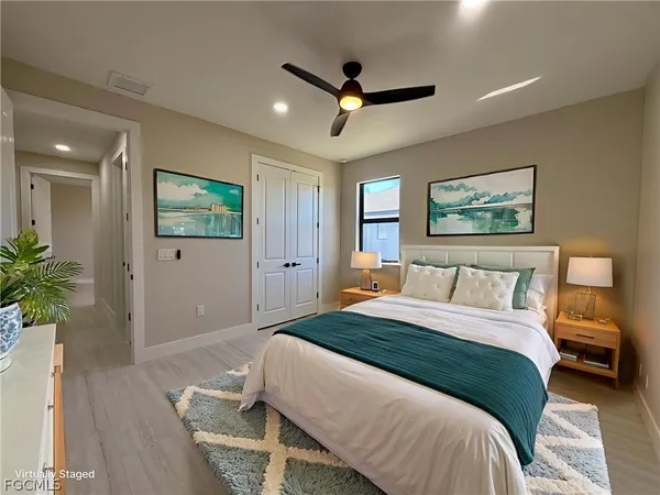 a bedroom with a large bed and a ceiling fan