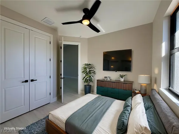 a bedroom with a bed and a flat screen tv