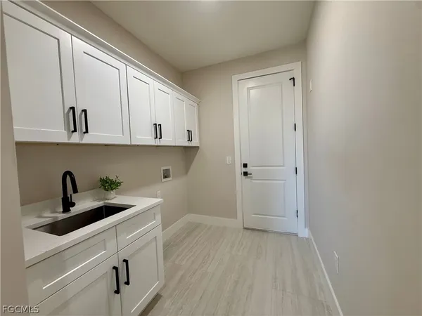 a view of cabinets a sink and dishwasher in a white cabinet