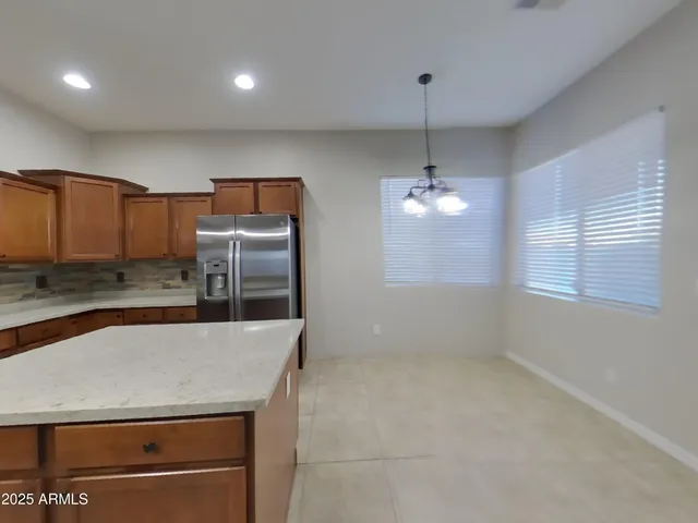 a view of an empty room with a kitchen