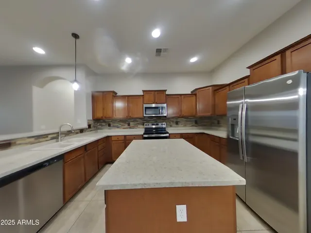 a kitchen with refrigerator and window