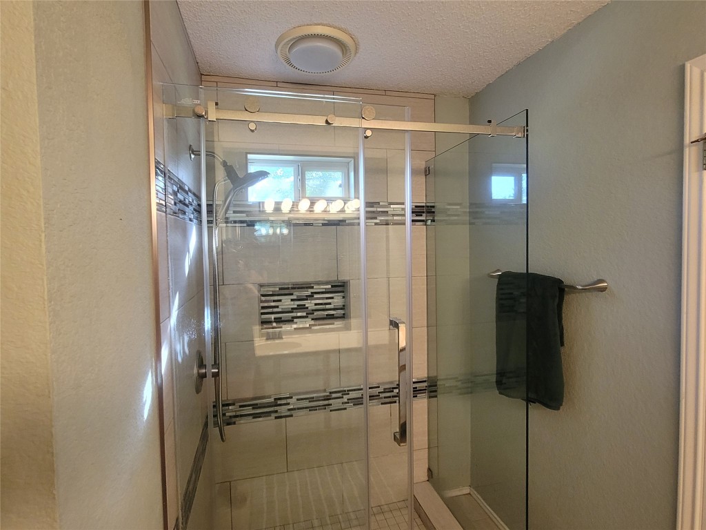 1805 Timber Ridge Drive Cedar Park, TX 78613 - Photo 21 of 25 a bathroom with a glass shower door
