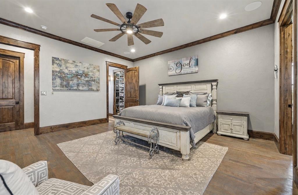 10641 County Road 632 Blue Ridge, TX 75424 - Photo 13 of 34 a bedroom with a large bed and a chandelier