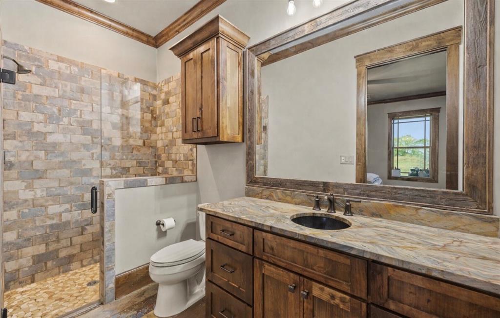 10641 County Road 632 Blue Ridge, TX 75424 - Photo 20 of 34 a bathroom with a sink a toilet and shower