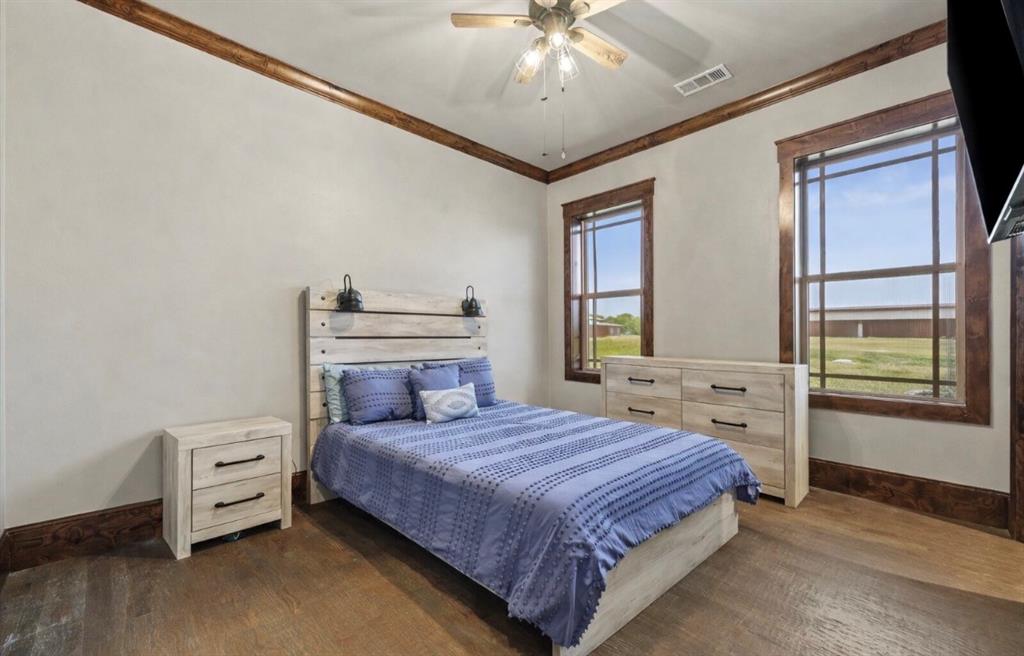 10641 County Road 632 Blue Ridge, TX 75424 - Photo 21 of 34 a bedroom with a bed and a chandelier