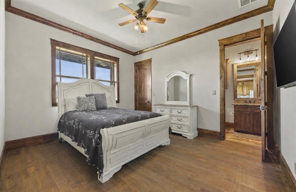 10641 County Road 632 Blue Ridge, TX 75424 - Photo 23 of 34 a bedroom with a bed and a chandelier