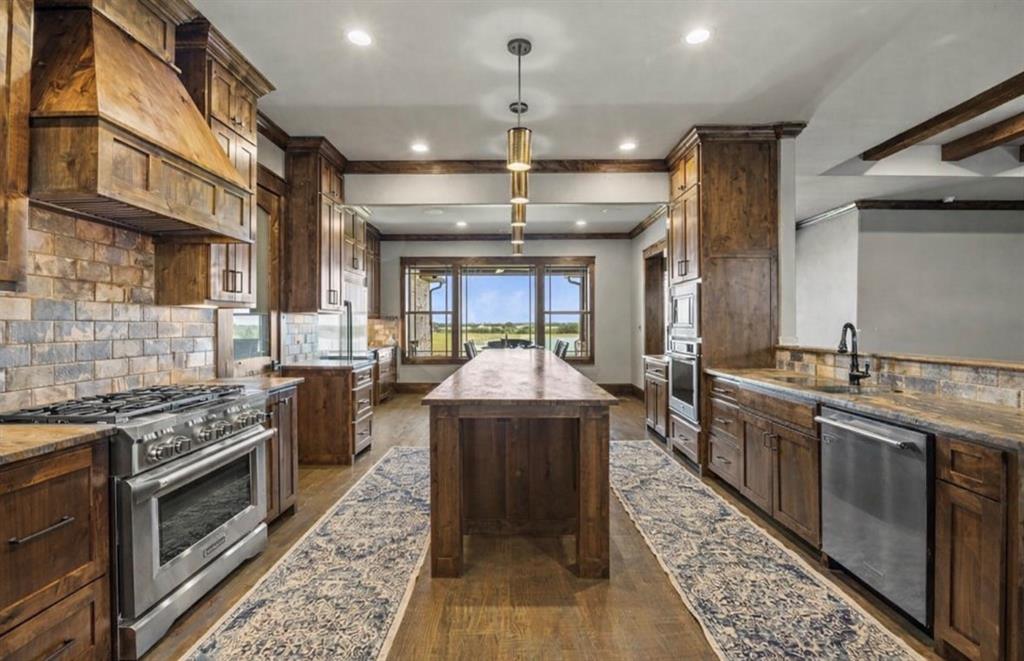 10641 County Road 632 Blue Ridge, TX 75424 - Photo 6 of 34 a kitchen with stainless steel appliances granite countertop a stove a sink dishwasher and a refrigerator