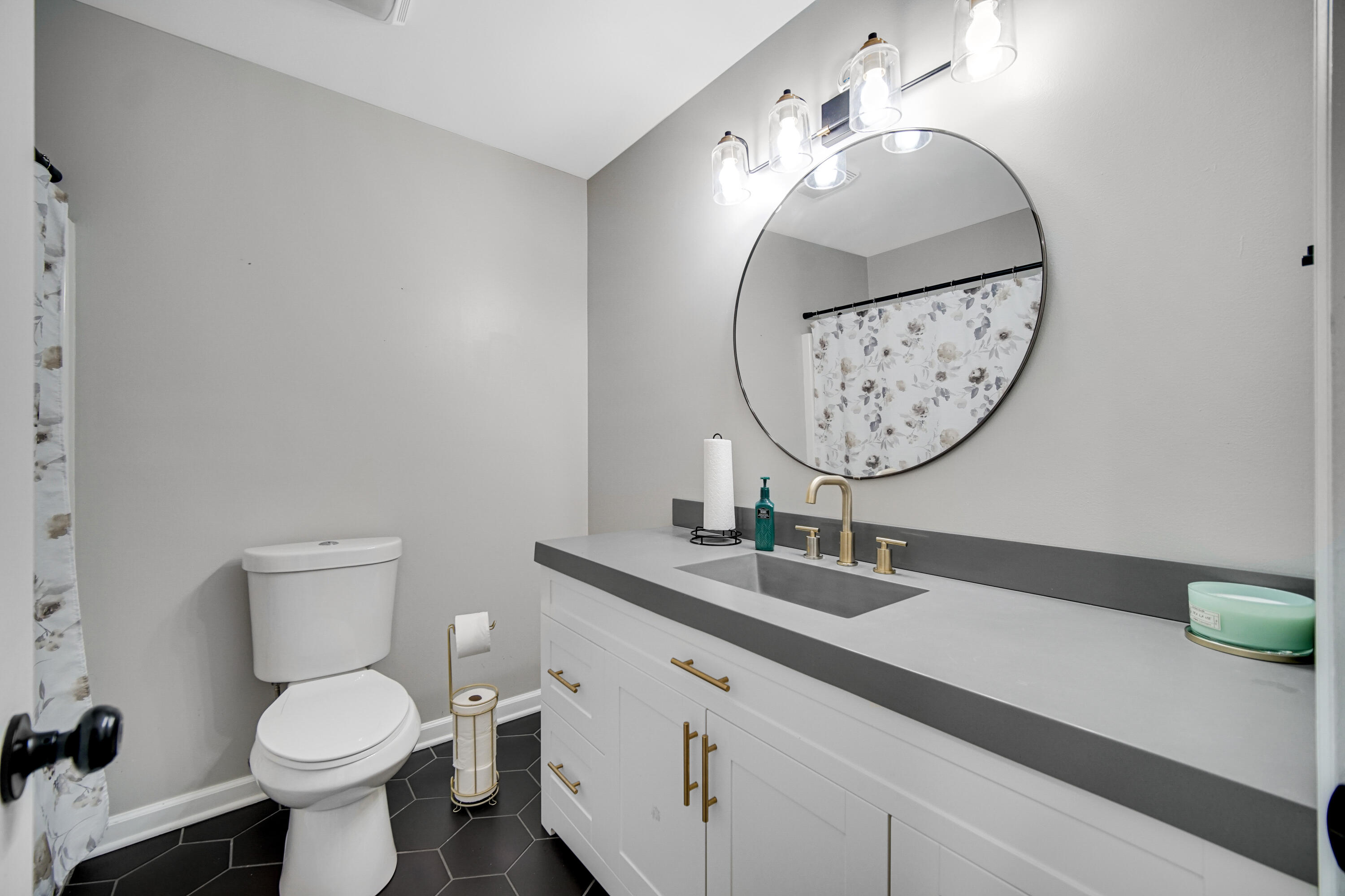 10487 Pinnacle Street Crown Point, IN 46307 - Photo 12 of 27 a bathroom with a toilet a sink and mirror