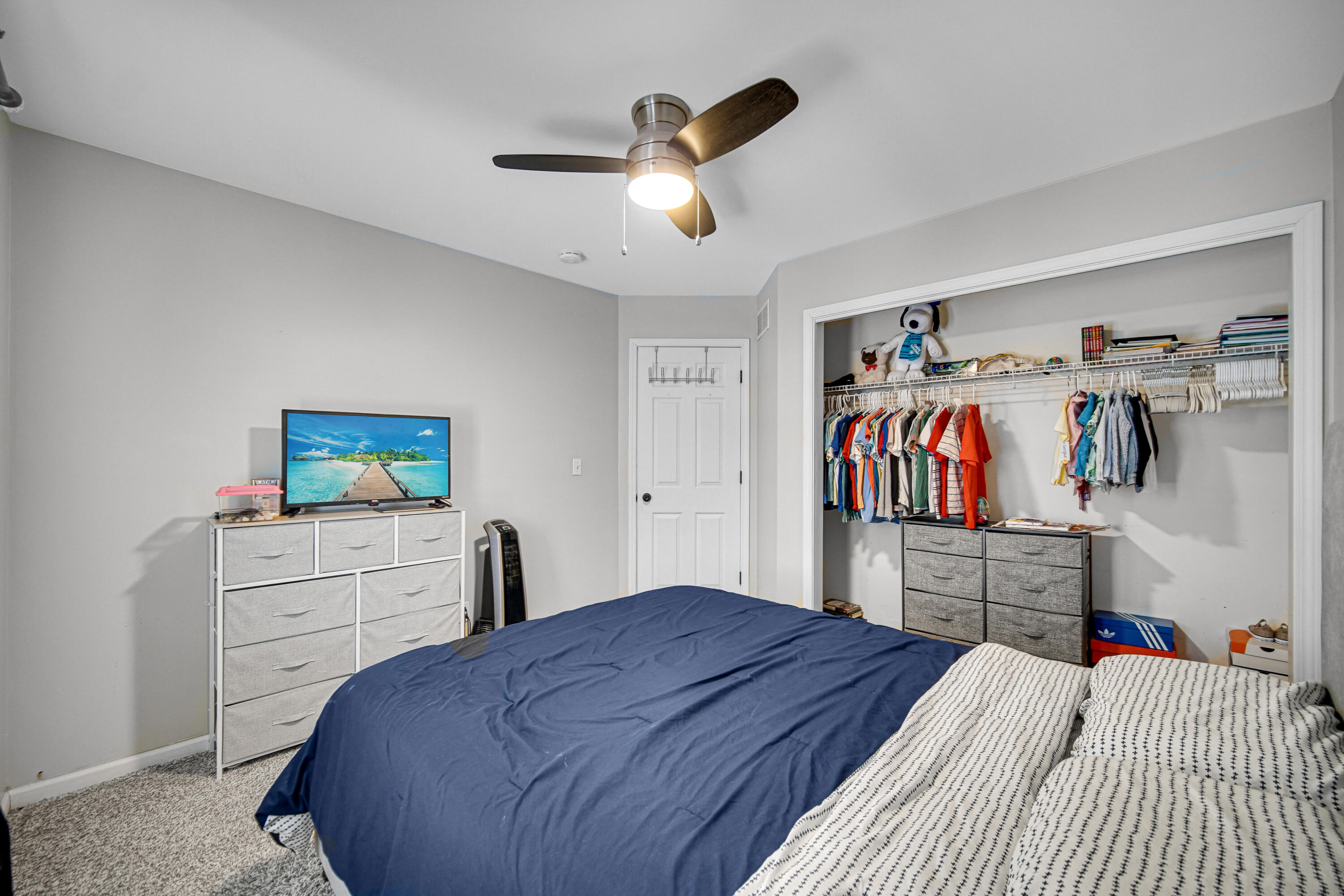 10487 Pinnacle Street Crown Point, IN 46307 - Photo 17 of 27 a bedroom with a bed and a chandelier