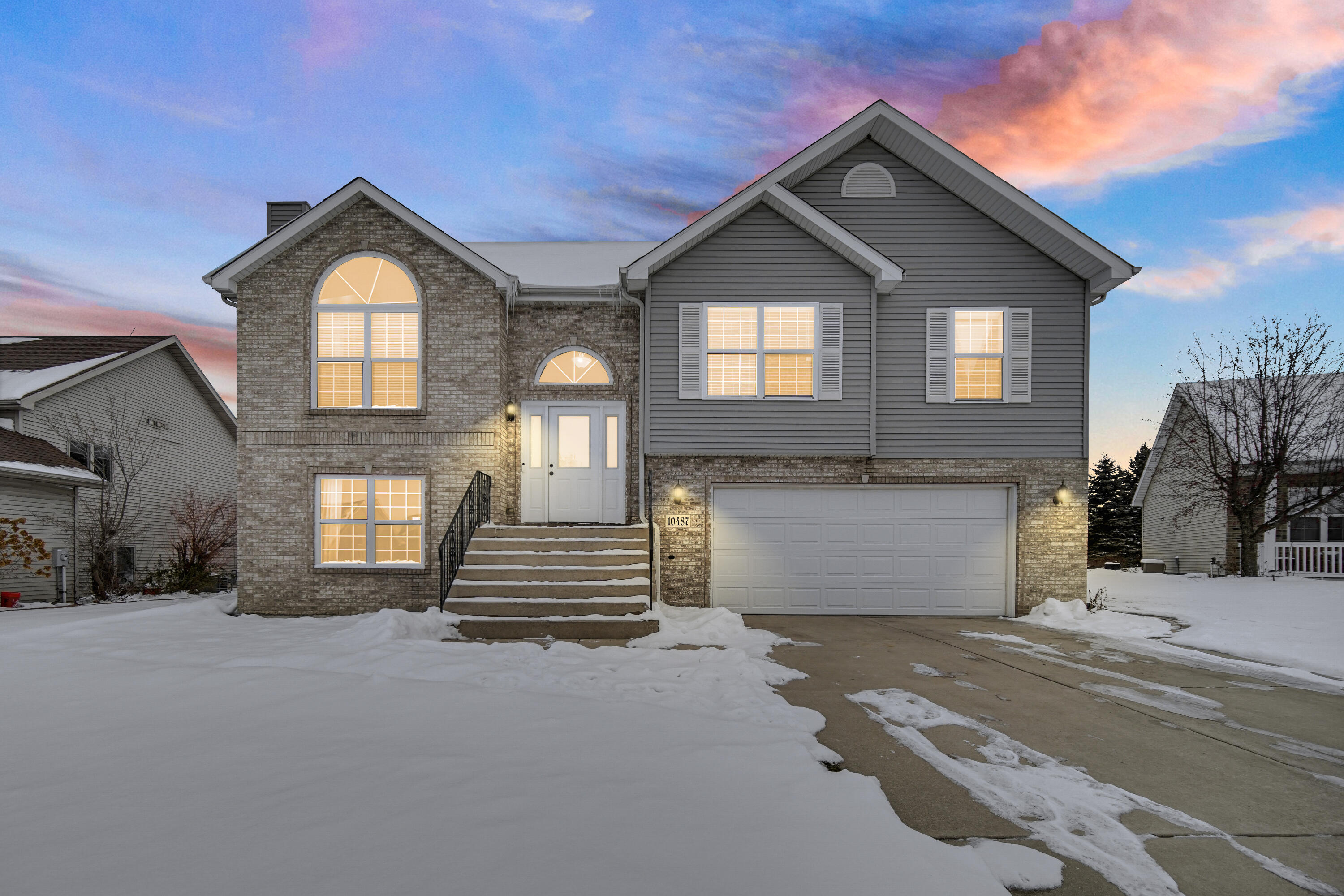 10487 Pinnacle Street Crown Point, IN 46307 - Photo 2 of 27 a front view of a house with a yard